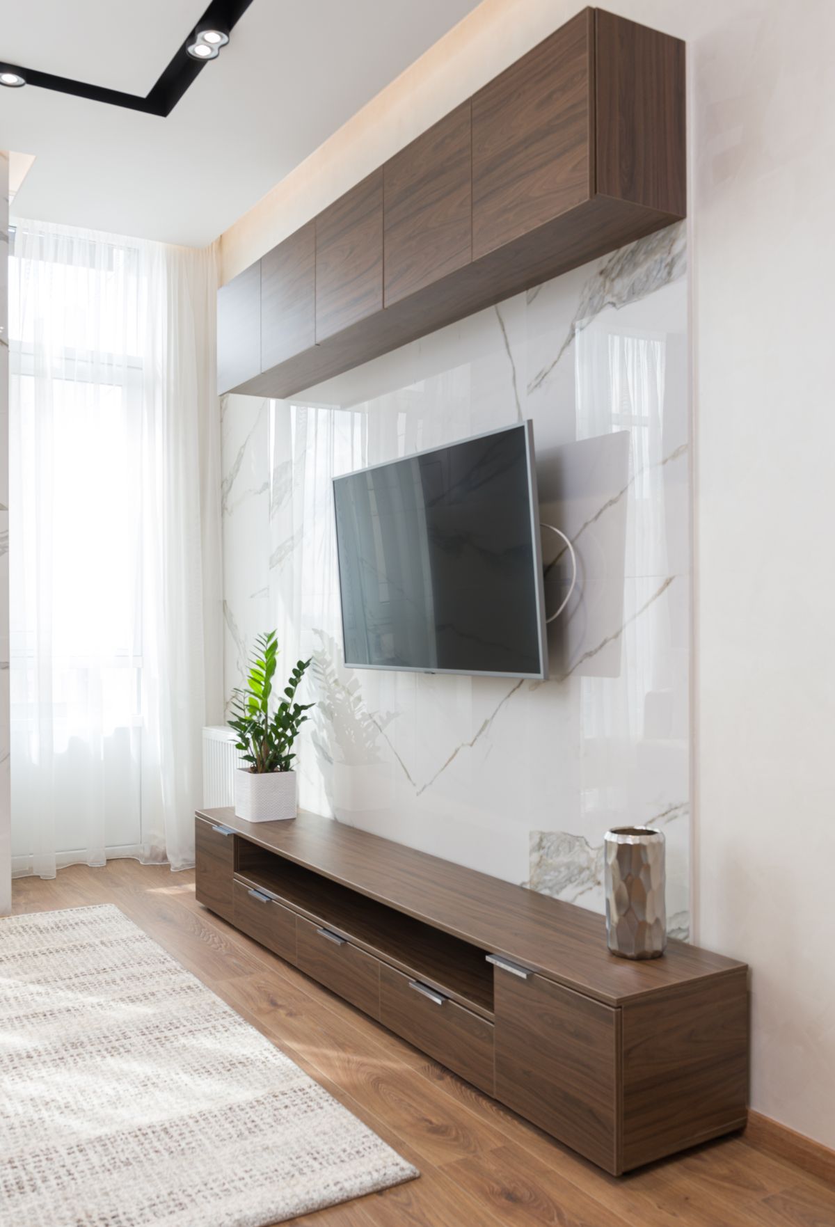 Inspiration: a TV mounted on a marble feature wall with a wood console below
